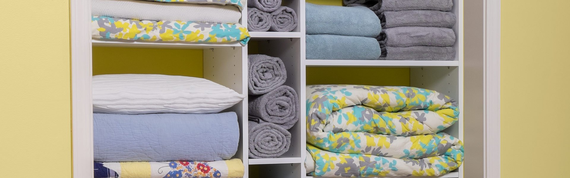 White linen closet with adjustable shelves