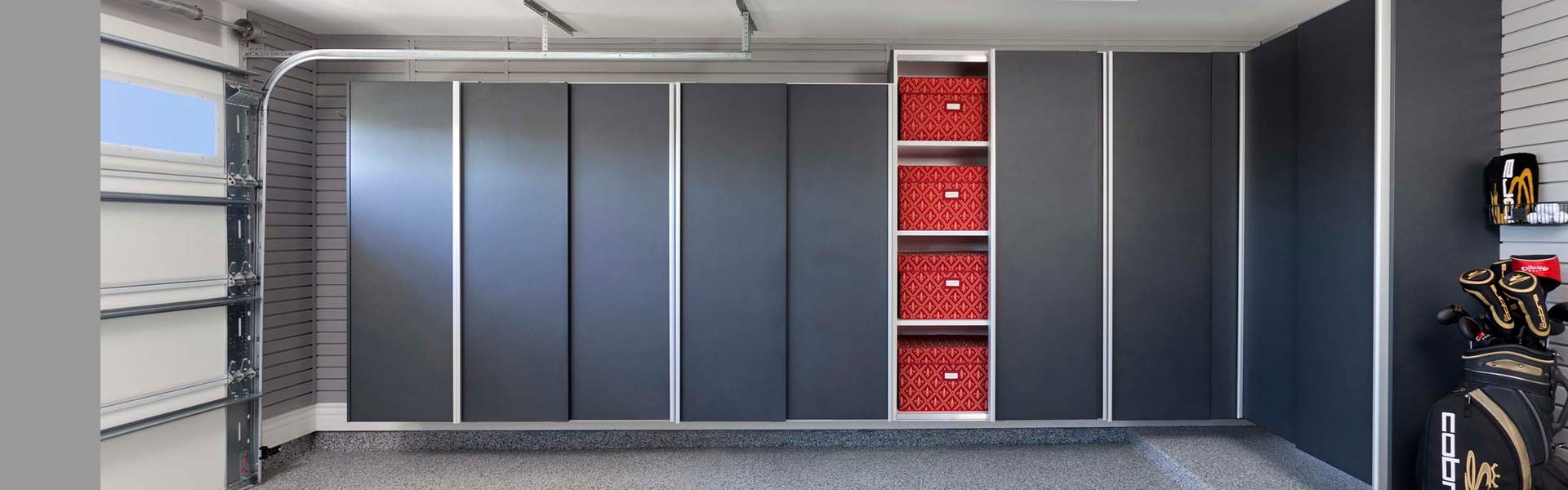 Garage storage system with sliding doors and slatwall