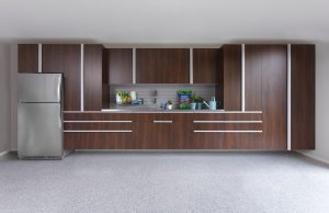 Custom garage cabinet installation with refrigerator and workbench.