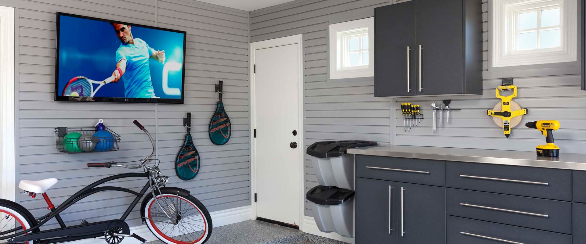 Slatwall storage in an organized garage with athletic equipment