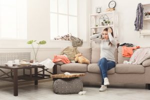 Woman sitting in a cluttered Phoenix-area living room