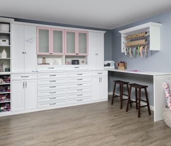 White and blush cabinet installation in a craft room.