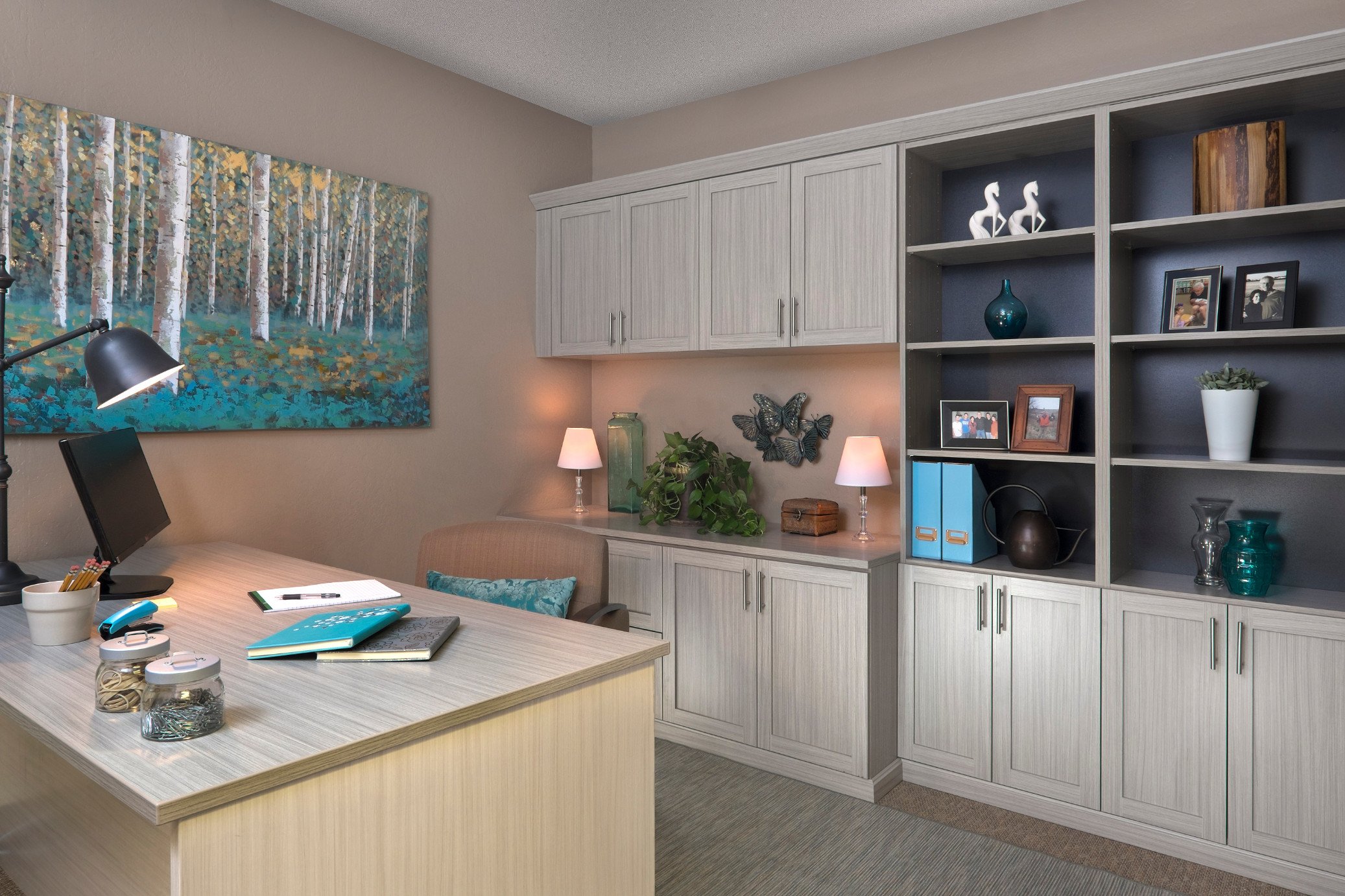 Custom home office with built in cabinets and bookshelves.