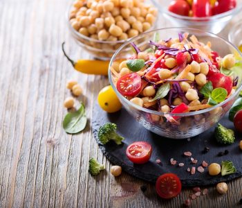 Close up of a salad on hard wood flooring.